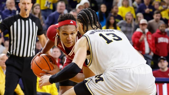 Dec 5, 2023; Ann Arbor, Michigan, USA; Indiana Hoosiers forward Malik Reneau (5) is defended by Michigan Wolverines forward Olivier Nkamhoua (13) in the second half at Crisler Center. Mandatory Credit: Rick Osentoski-USA TODAY Sports